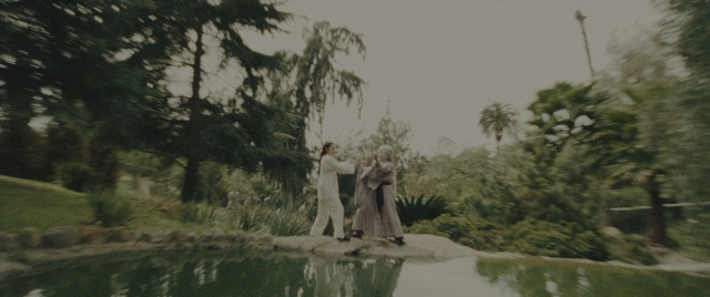 Wide shot frame from Everything Everywhere All at Once — standing, dress, water