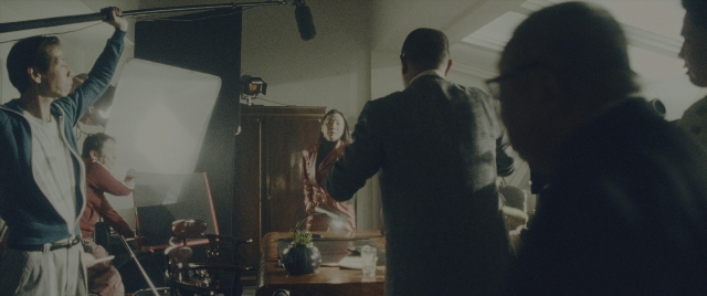 Wide shot frame from Everything Everywhere All at Once — standing, room, dialogue