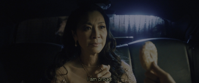 Medium shot frame from Everything Everywhere All at Once — sitting, car, hand