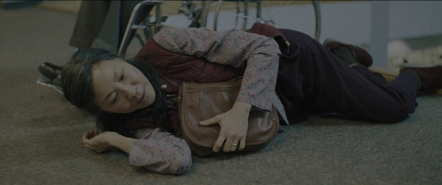 Wide shot frame from Everything Everywhere All at Once — bag, person, human face