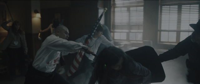 Wide shot frame from Everything Everywhere All at Once — standing, room, table