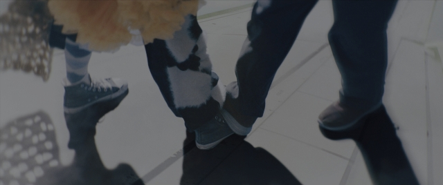 Wide shot frame from Everything Everywhere All at Once — walking, coat, person