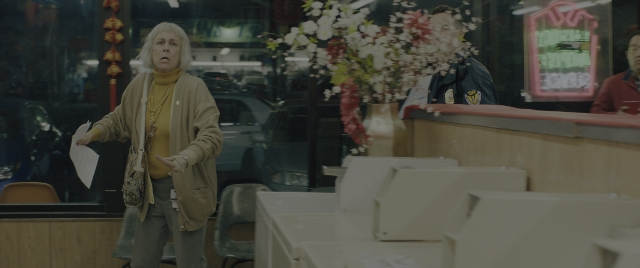 Wide shot frame from Everything Everywhere All at Once — sitting, standing, table