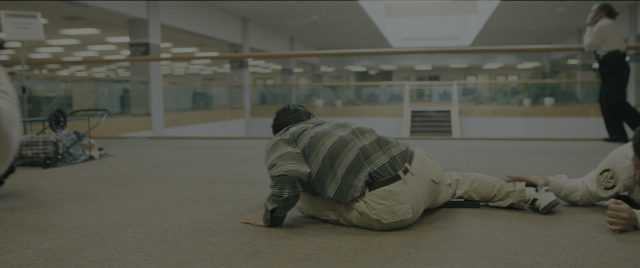 Wide shot frame from Everything Everywhere All at Once — walking, shirt, person