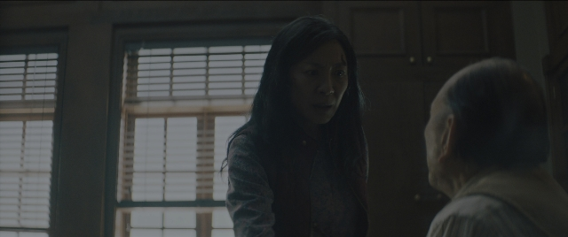 Wide shot frame from Everything Everywhere All at Once — standing, room, door