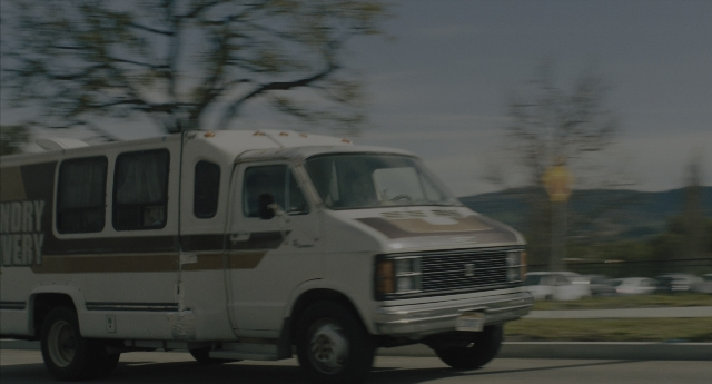 Wide shot frame from Everything Everywhere All at Once — street, van, wheel