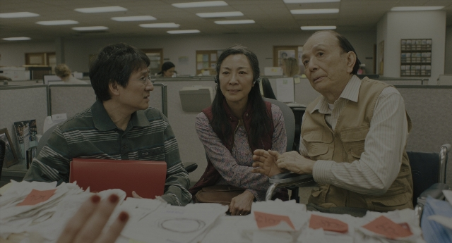Wide shot frame from Everything Everywhere All at Once — sitting, book, dialogue