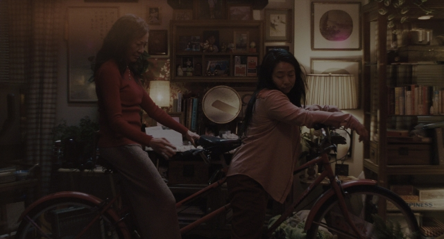 Wide shot frame from Everything Everywhere All at Once — standing, room, bicycle