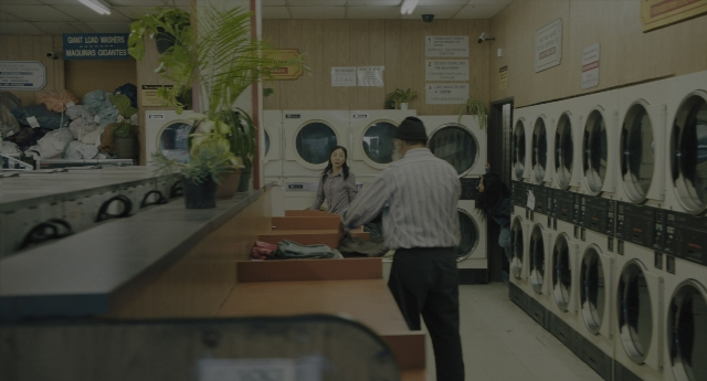 Wide shot frame from Everything Everywhere All at Once — standing, room, hat