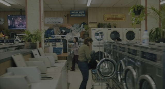 Wide shot frame from Everything Everywhere All at Once — standing, room, person
