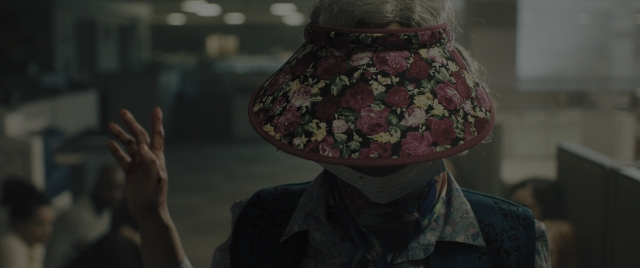 Wide shot frame from Everything Everywhere All at Once — standing, room, hat