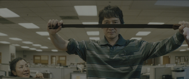 Wide shot frame from Everything Everywhere All at Once — sitting, standing, shirt