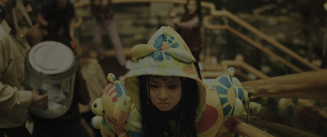 Wide shot frame from Everything Everywhere All at Once — standing, person, human face