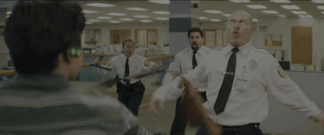 Wide shot frame from Everything Everywhere All at Once — room, door, face