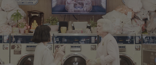 Wide shot frame from Everything Everywhere All at Once — standing, room, person