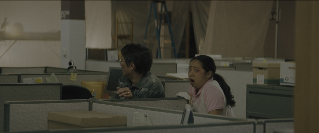 Wide shot frame from Everything Everywhere All at Once — sitting, standing, dialogue