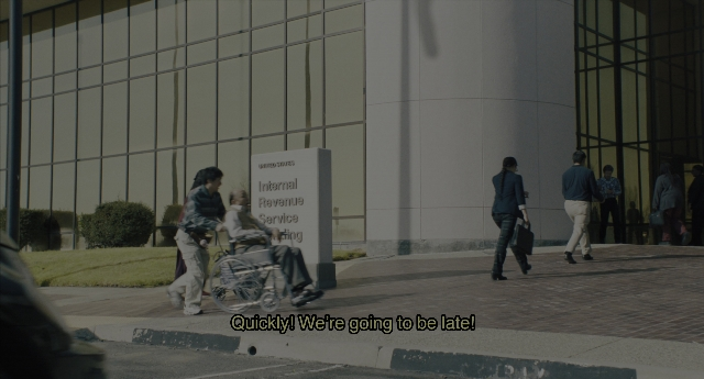 Wide shot frame from Everything Everywhere All at Once — walking, street, shirt