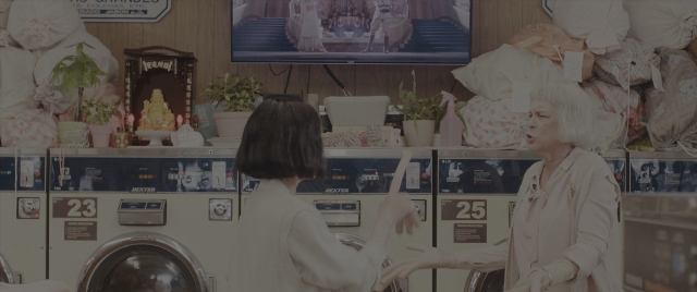 Wide shot frame from Everything Everywhere All at Once — standing, room, person
