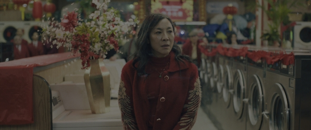 Wide shot frame from Everything Everywhere All at Once — standing, room, coat