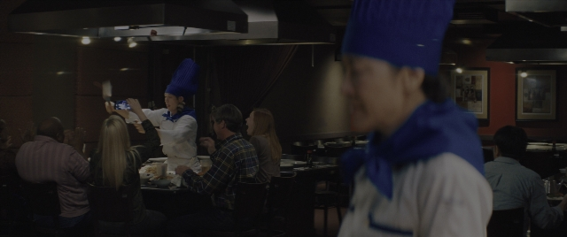 Wide shot frame from Everything Everywhere All at Once — sitting, dialogue, kitchen