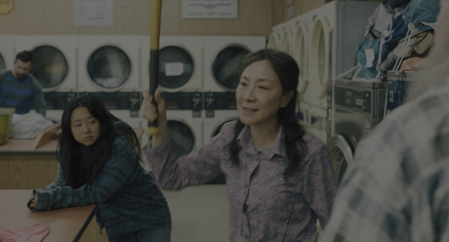 Wide shot frame from Everything Everywhere All at Once — sitting, standing, room