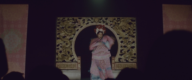 Wide shot frame from Everything Everywhere All at Once — standing, hand, dress