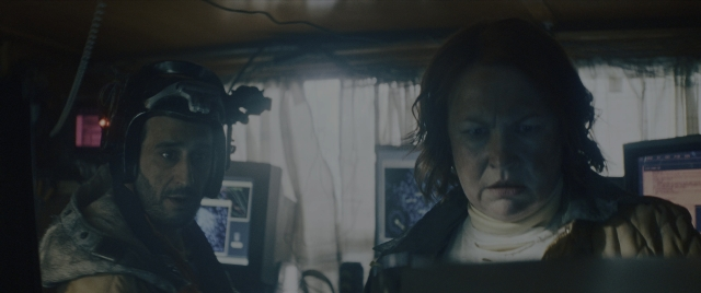 Medium shot frame from Everything Everywhere All at Once — sitting, room, hat