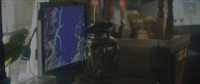 Wide shot frame from Everything Everywhere All at Once — bottle, cup, window