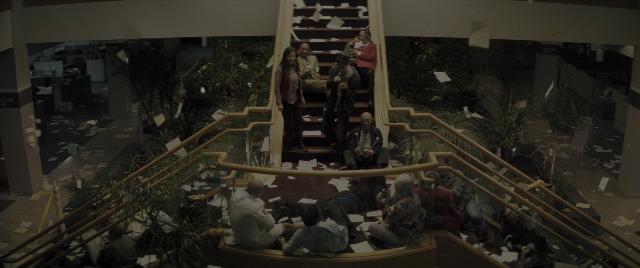 Wide shot frame from Everything Everywhere All at Once — sitting, standing, room
