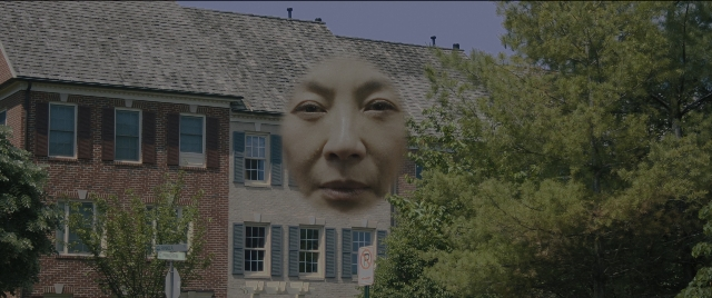 Medium shot frame from Everything Everywhere All at Once — street, house, face
