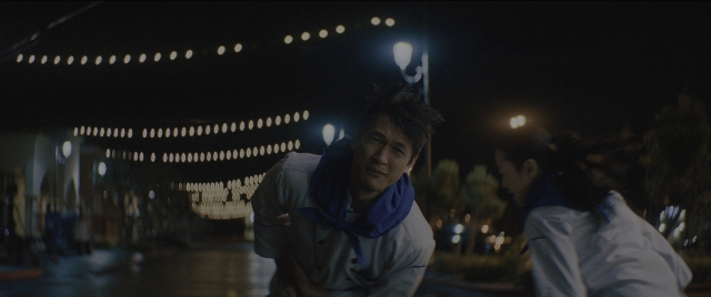 Wide shot frame from Everything Everywhere All at Once — standing, street, night