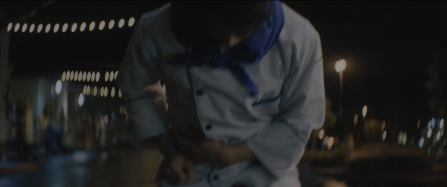 Medium shot frame from Everything Everywhere All at Once — sitting, standing, room