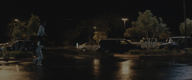 Wide shot frame from Everything Everywhere All at Once — walking, street, car