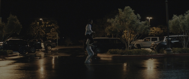 Wide shot frame from Everything Everywhere All at Once — walking, street, car