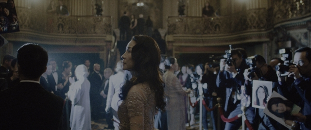 Wide shot frame from Everything Everywhere All at Once — standing, room, dress
