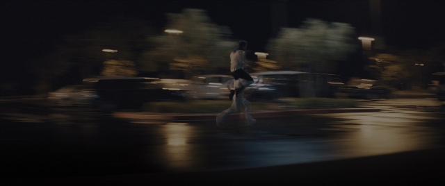 Frame from Everything Everywhere All at Once — walking, street, car