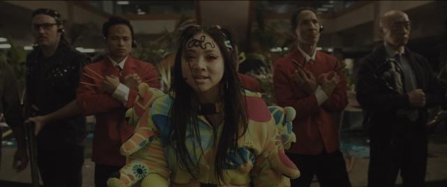 Wide shot frame from Everything Everywhere All at Once — standing, room, suit