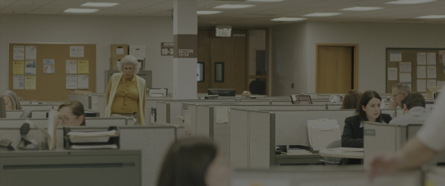 Wide shot frame from Everything Everywhere All at Once — sitting, room, office