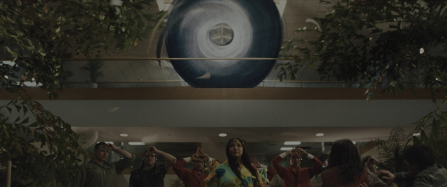 Wide shot frame from Everything Everywhere All at Once — standing, room, person