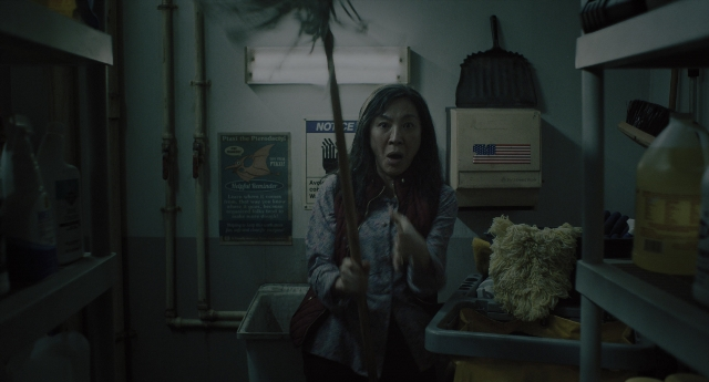 Wide shot frame from Everything Everywhere All at Once — standing, room, shirt