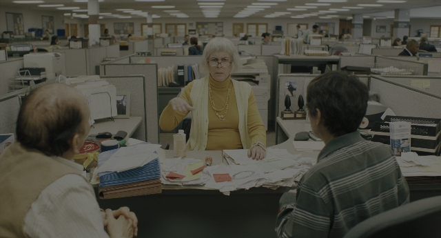 Wide shot frame from Everything Everywhere All at Once — sitting, book, standing