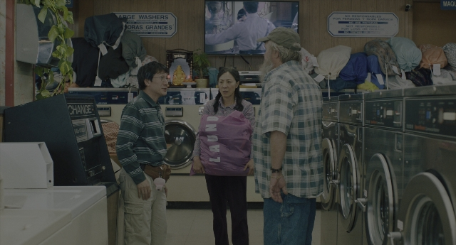 Wide shot frame from Everything Everywhere All at Once — standing, room, dialogue