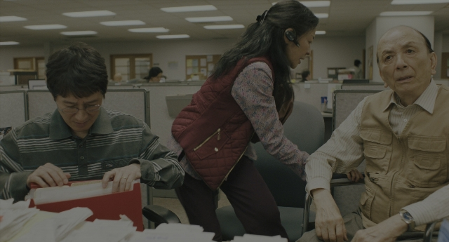 Wide shot frame from Everything Everywhere All at Once — sitting, standing, shirt
