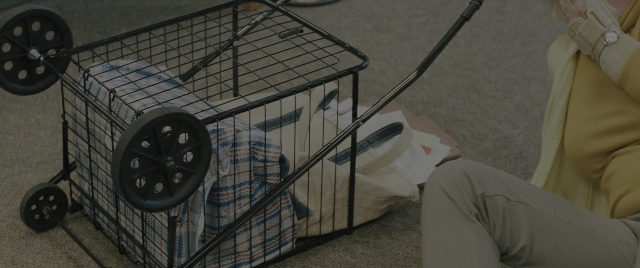 Wide shot frame from Everything Everywhere All at Once — sitting, hat, hand