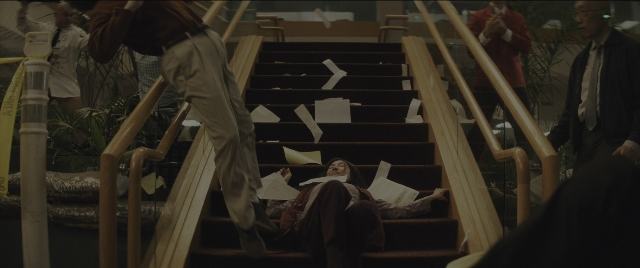 Wide shot frame from Everything Everywhere All at Once — dialogue, suit, person