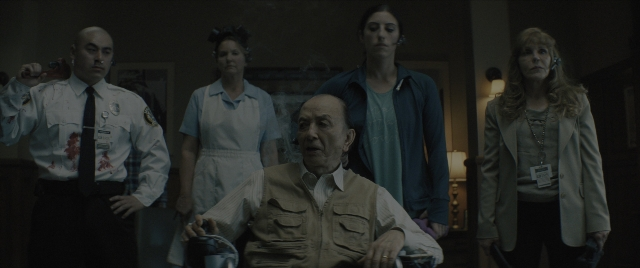 Wide shot frame from Everything Everywhere All at Once — sitting, standing, room
