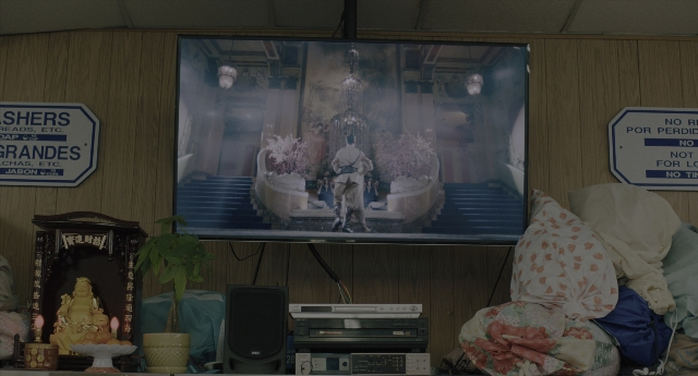 Wide shot frame from Everything Everywhere All at Once — standing, room, door