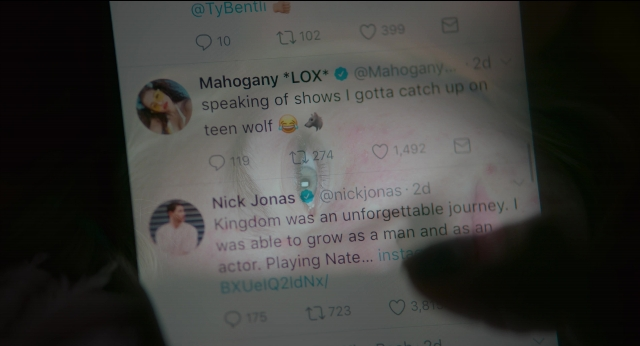 Wide shot frame from Eighth Grade — dialogue, phone, shirt