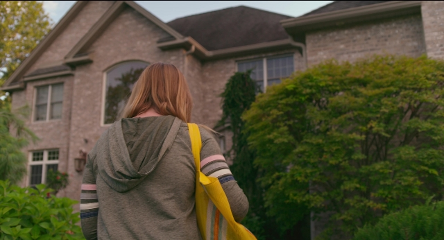 Wide shot frame from Eighth Grade — standing, house, person