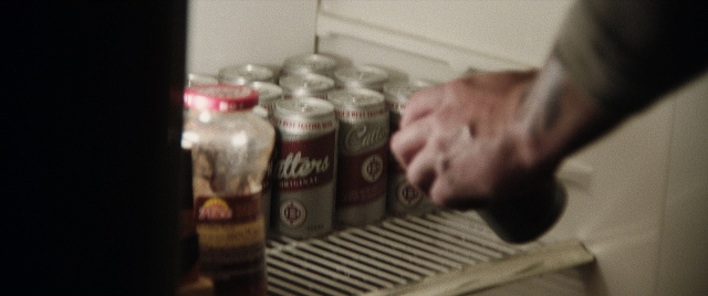 Frame from The Way Back — hat, refrigerator, hand